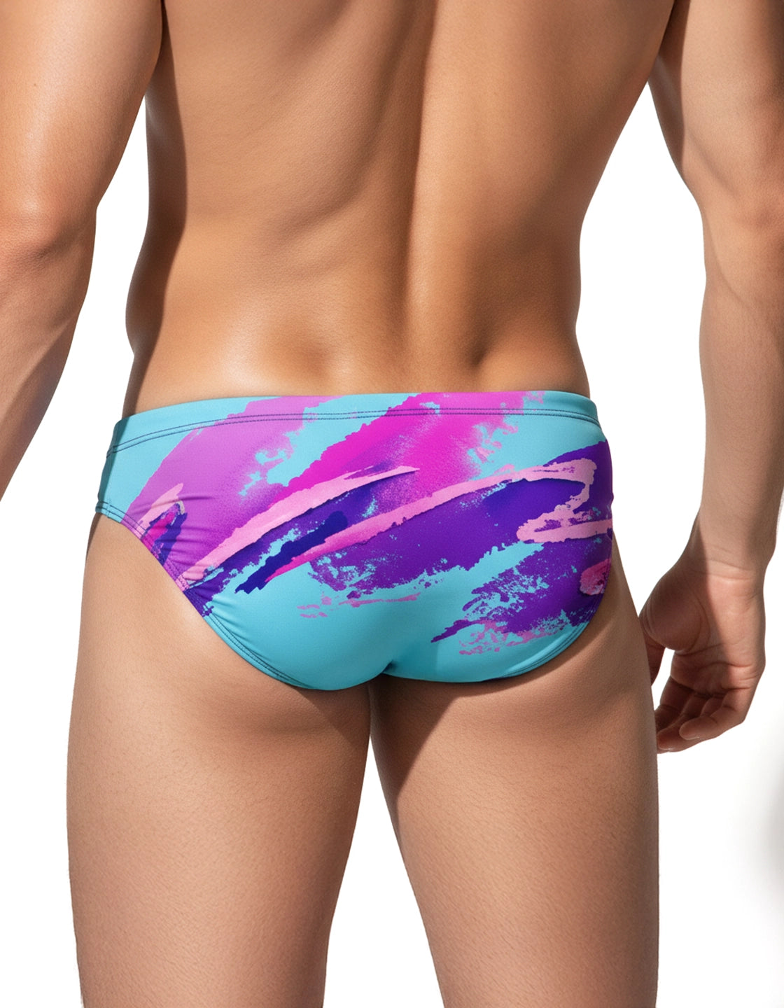 Back view of a male model wearing a speedo-style swim brief with a 90s-Jazz-inspired pattern (blue, pink and purple) on a white background by PARADIS SVP