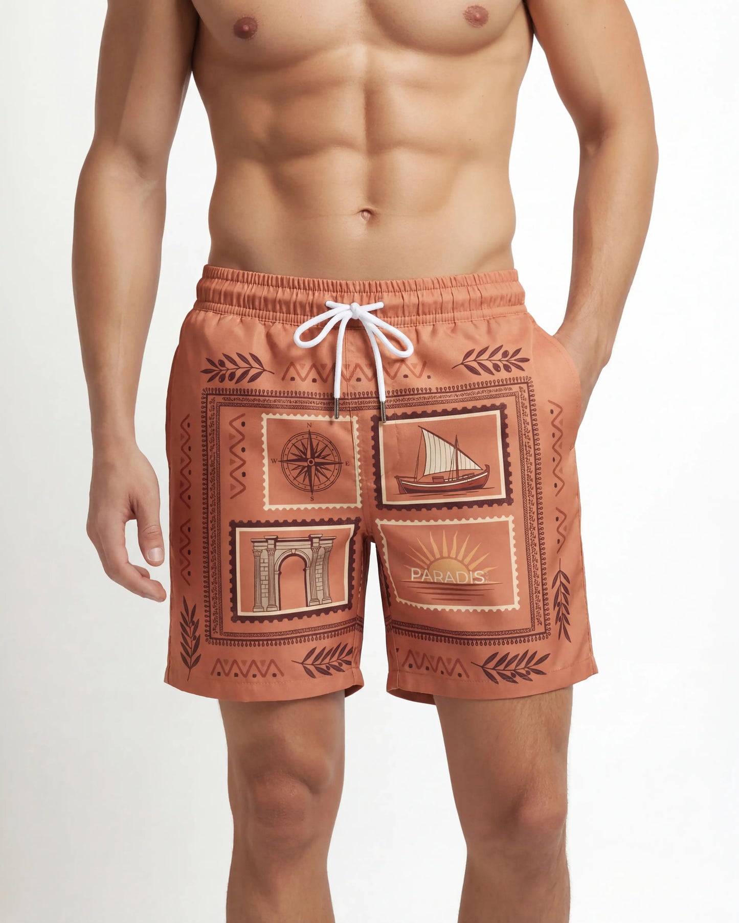 Man wearing patterned salmon orange swim shorts on a white background