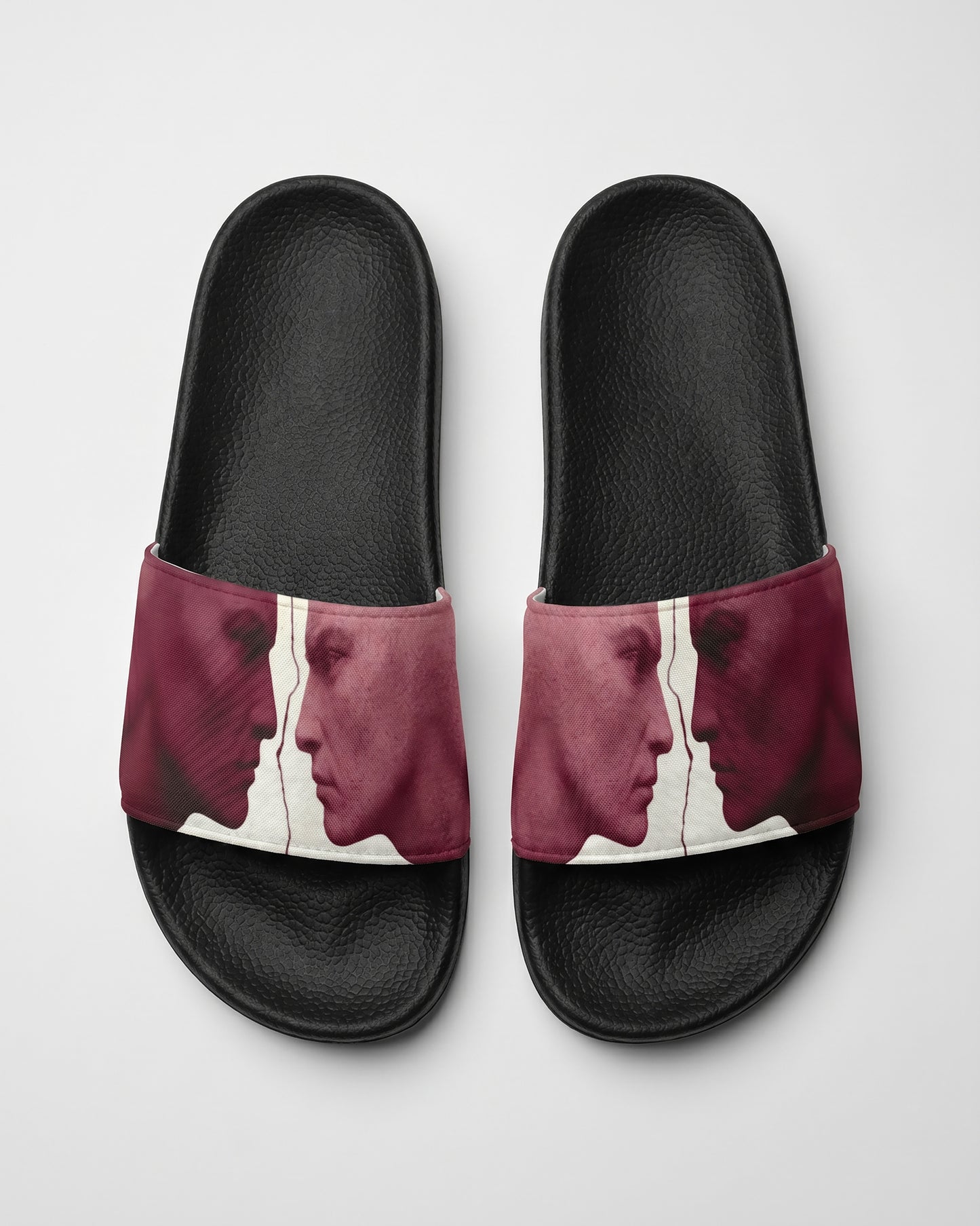Burgundy and white Pair of slides with artistic design of two statue faces on a white background