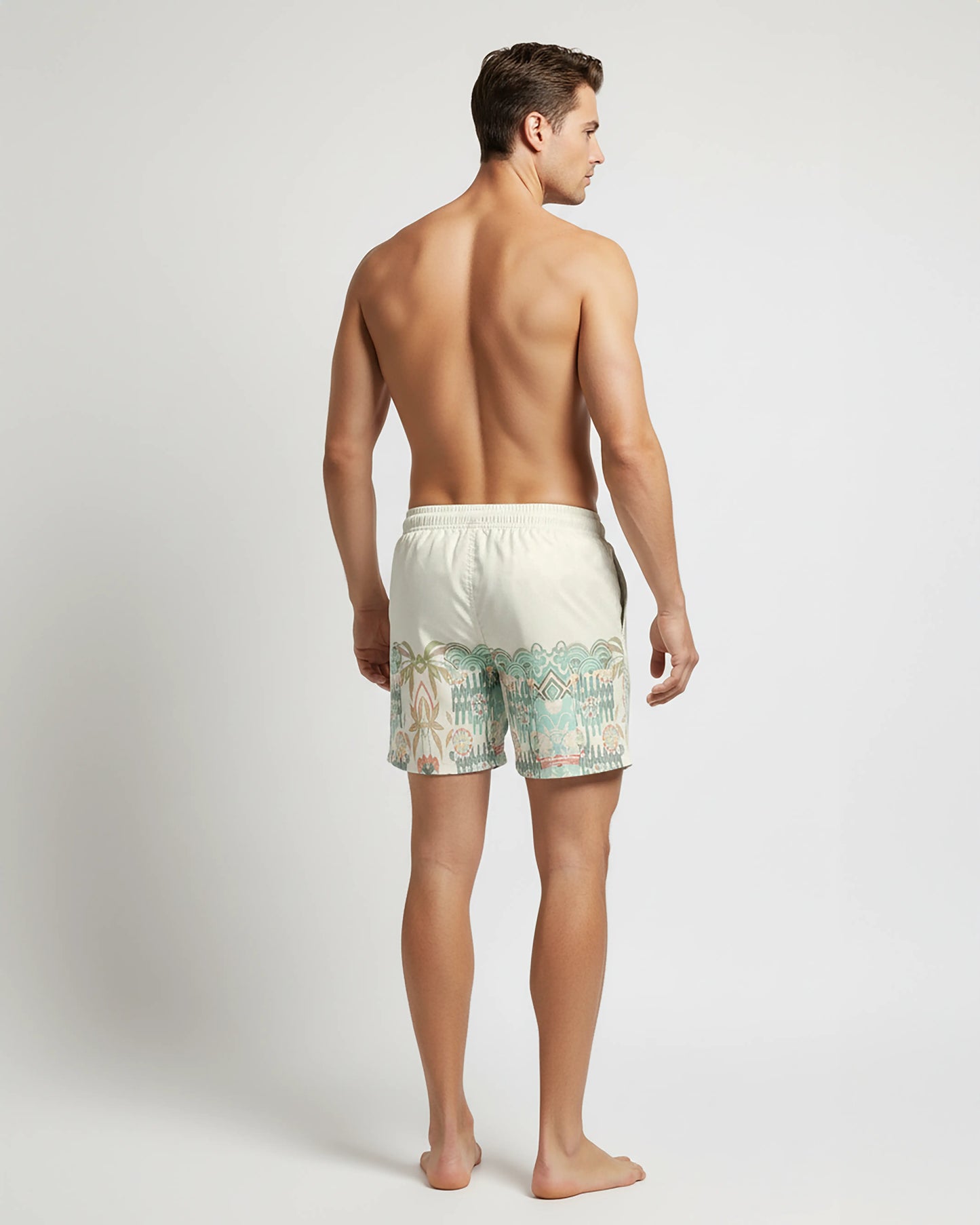Full back View of Man wearing beige with aztec pattern swim shorts on a white background by PARADIS SVP