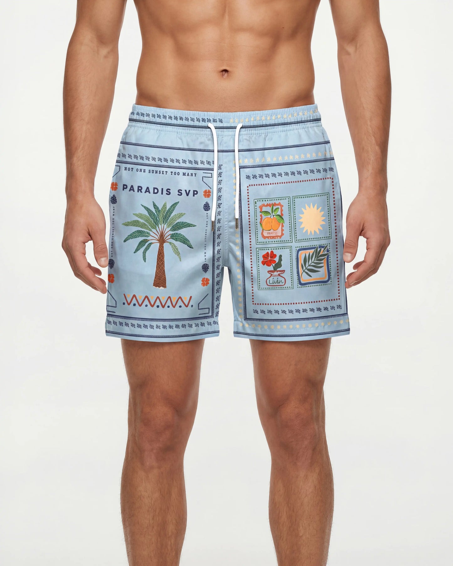 Man wearing light blue patterned swim shorts on a plain background