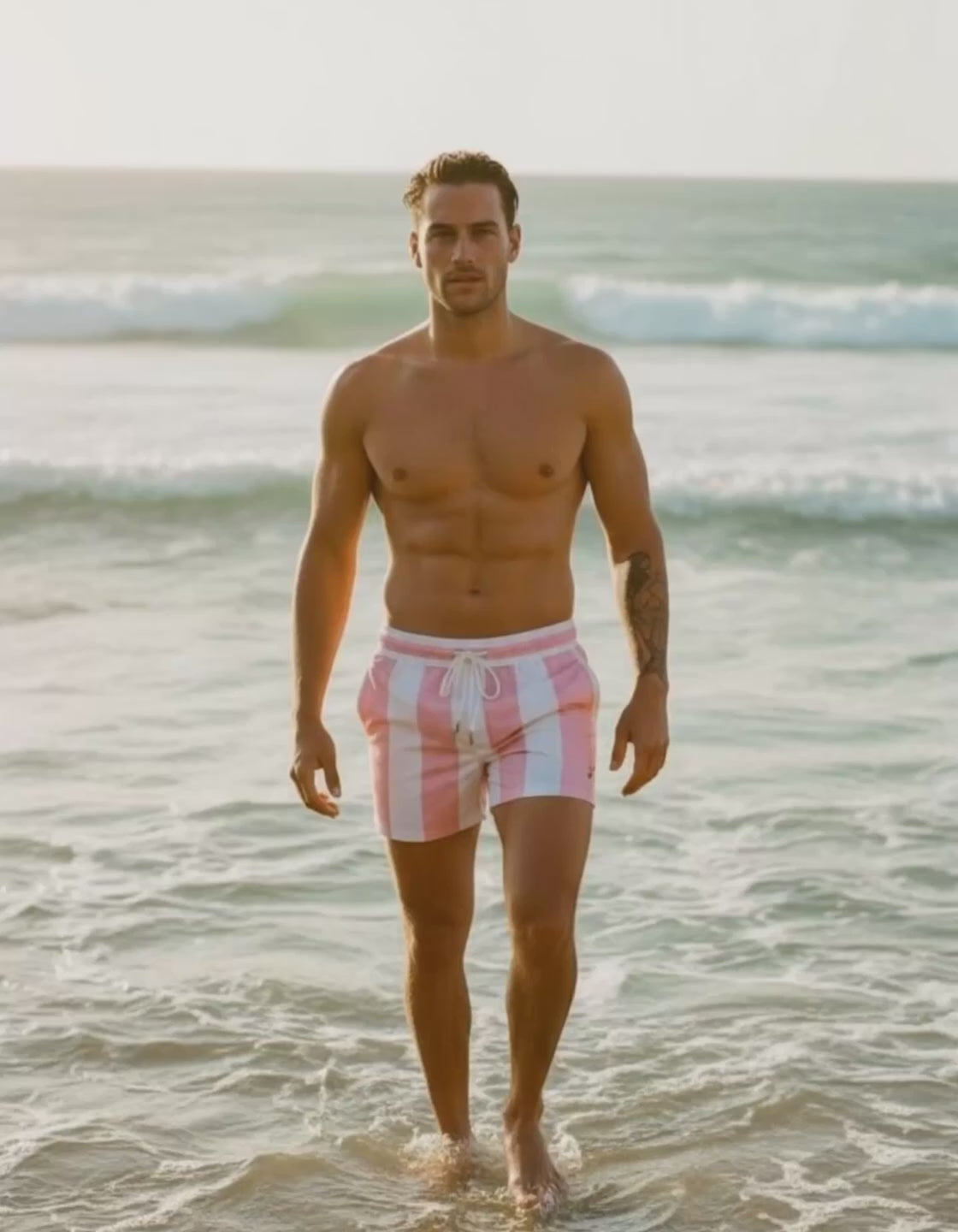 man wearing a PARADIS SVP pink-striped beach shorts at the beach